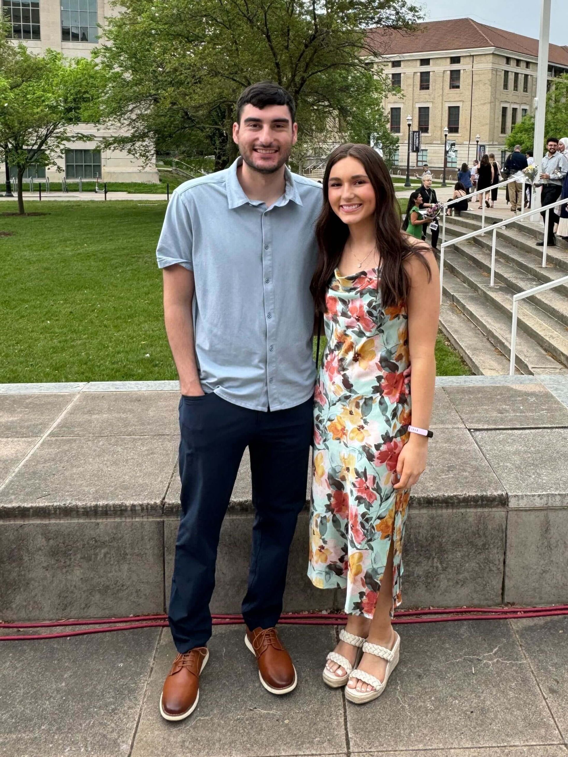Young couple standing together outdoors at a university campus