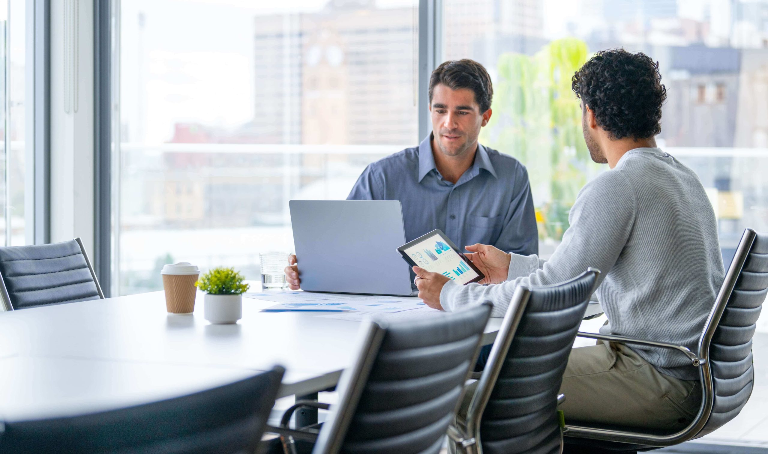 Financial advisor meeting with a client to review financial data and investment planning