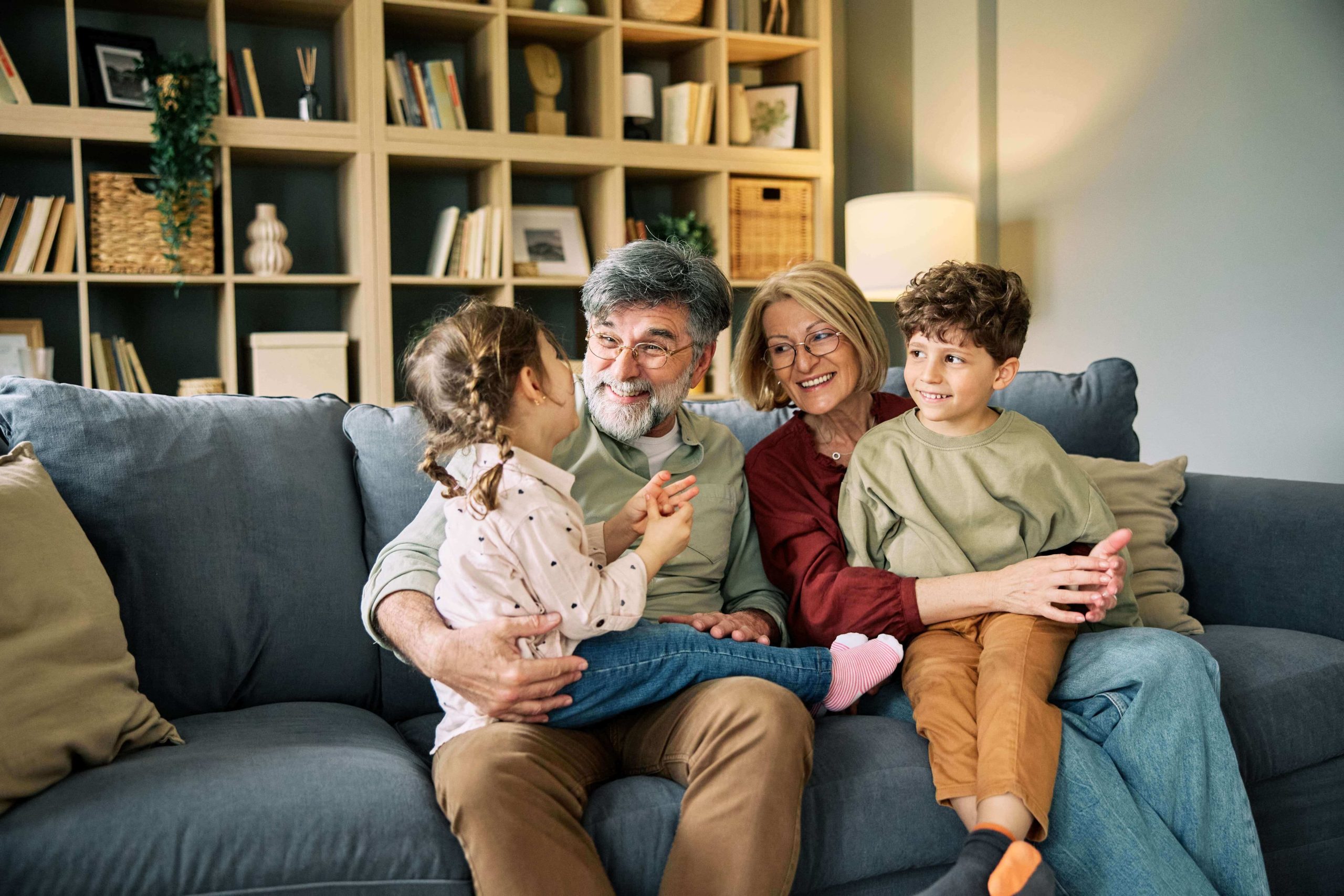 Retired couple spending time at home with their grandchildren