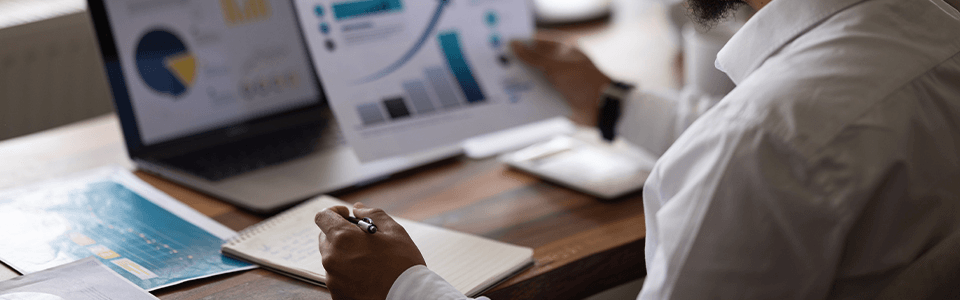 Financial professional analyzing investment charts and financial data
